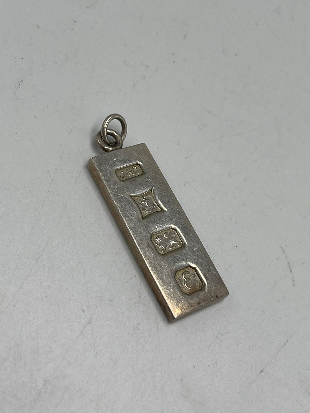 Lot 662: A Sterling Silver Ingot Pendant by JRT?, Birmingham, 1981, 16g