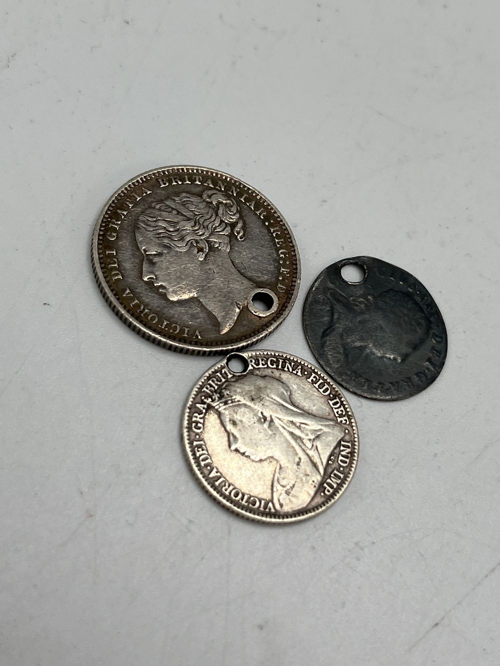 Lot 669: A Trio of Victorian UK Silver? Coins, One Shilling, Sixpence and Threepence, 9.66g