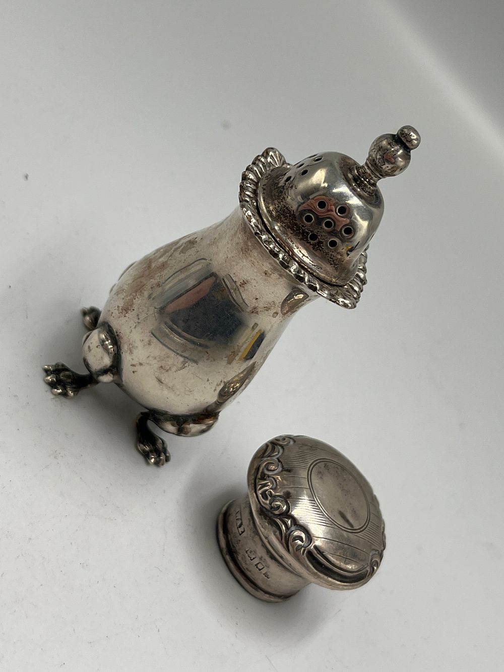 Lot 682: A  Late Victorian Sterling Silver Pepper Shakers by Mappin & Webb, Sheffield, 1897, plus silver lid 49.26g