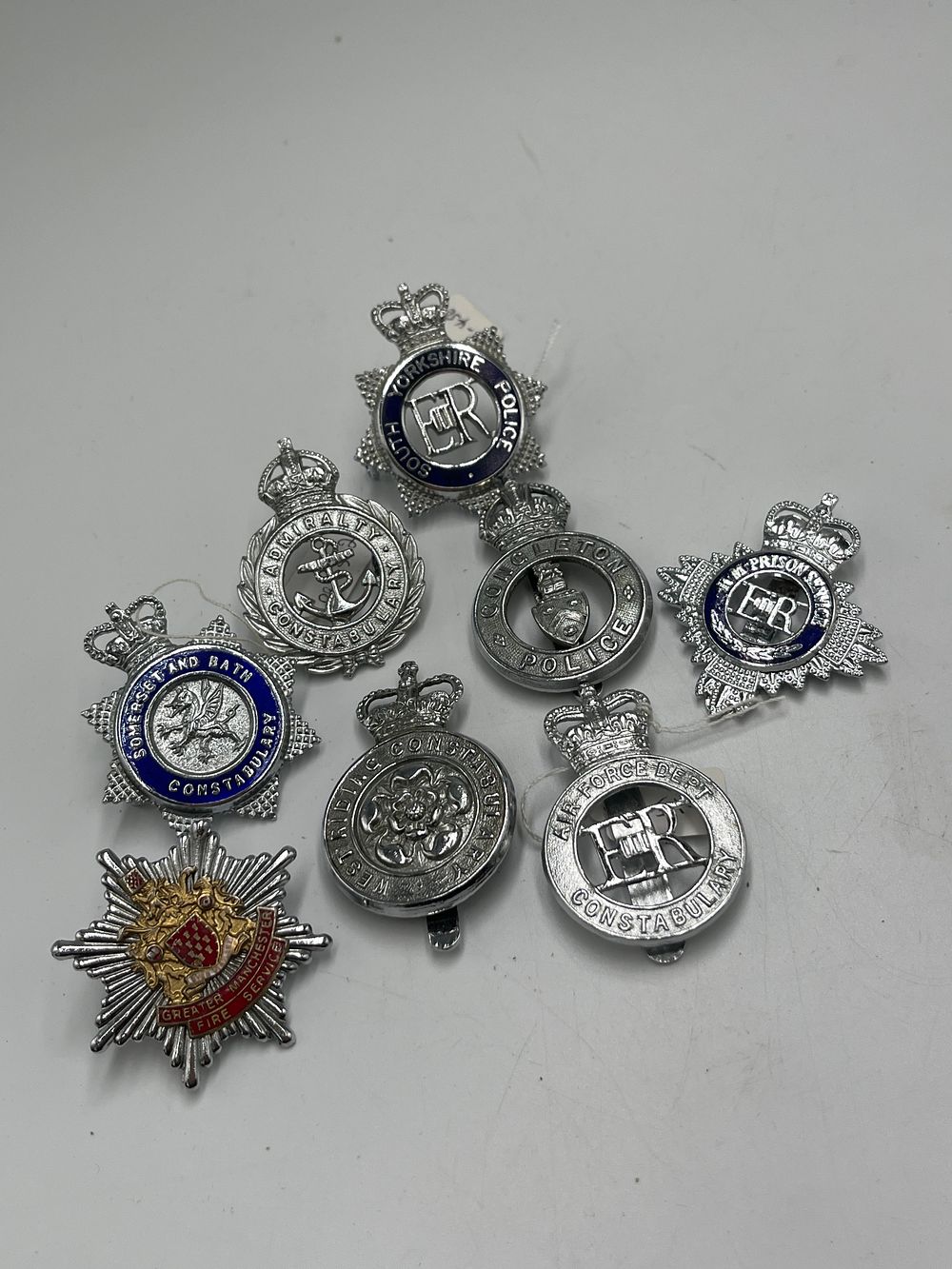 Lot 694: A Collection of British Police and Emergency Service White Metal and Enamel Cap Badges