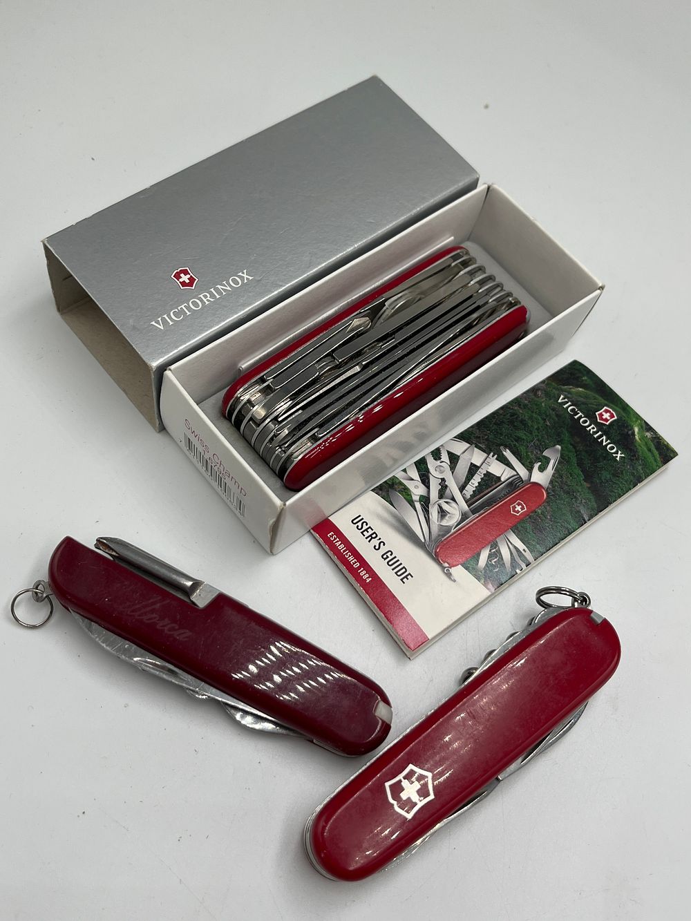 Lot 696: Victorinox SwissChamp 1.6795 Multi-tool and Two Additional Pocket Knives