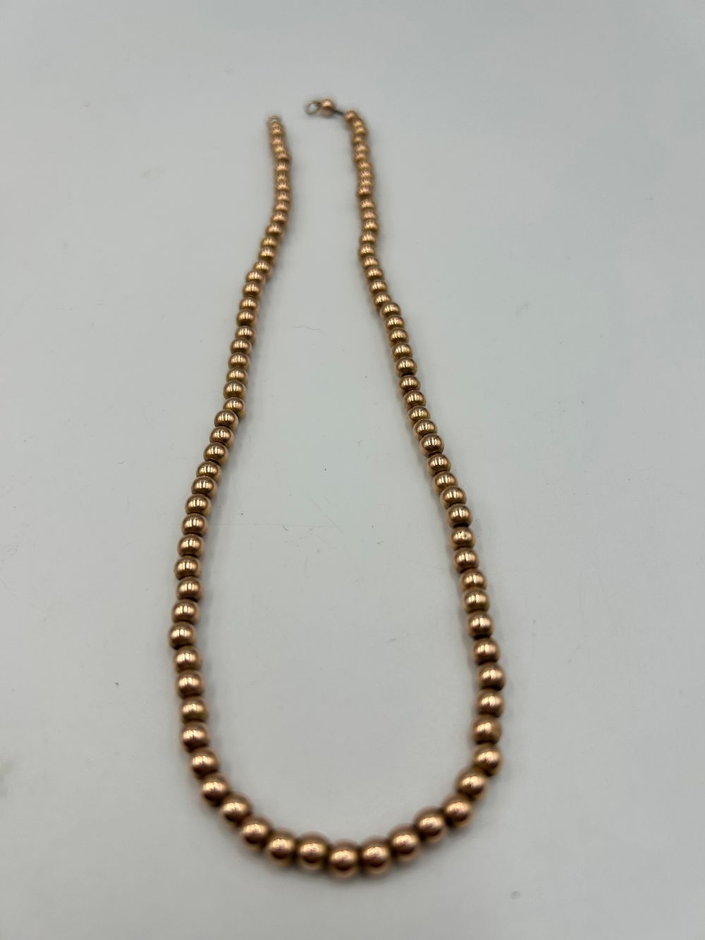 Lot 708: Graduated 9 Carat Gold Bead Necklace, 12.27g