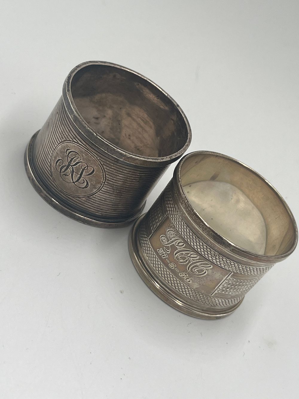 Lot 726: George V Sterling Silver Napkin Rings by Henry Williamson Ltd and Atkins Brothers, Birmingham and Sheffield, 1914 and 1934, 46g