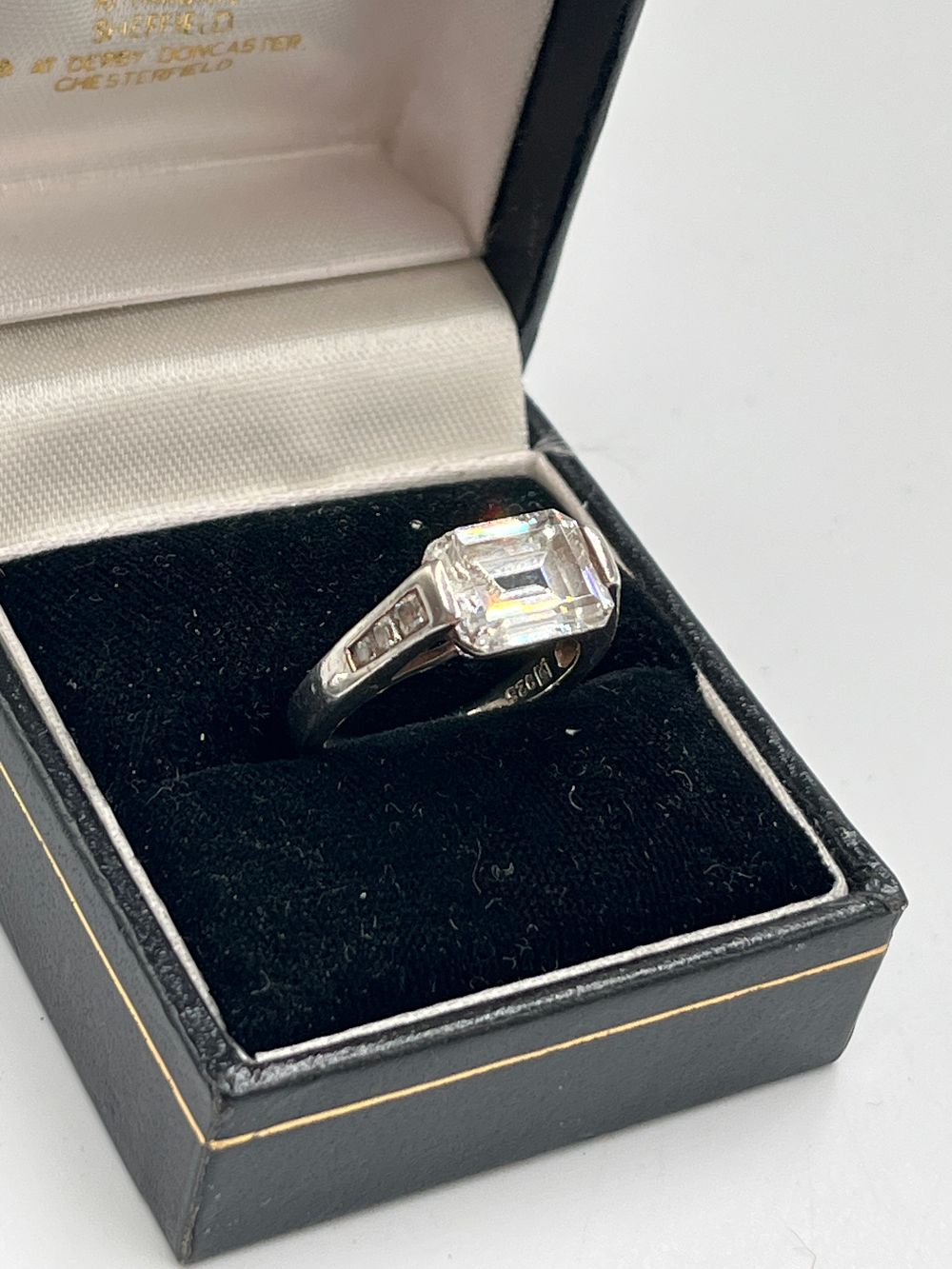 Lot 733: Sterling Silver Emerald Cut Colourless Stone Solitaire Ring, Size L