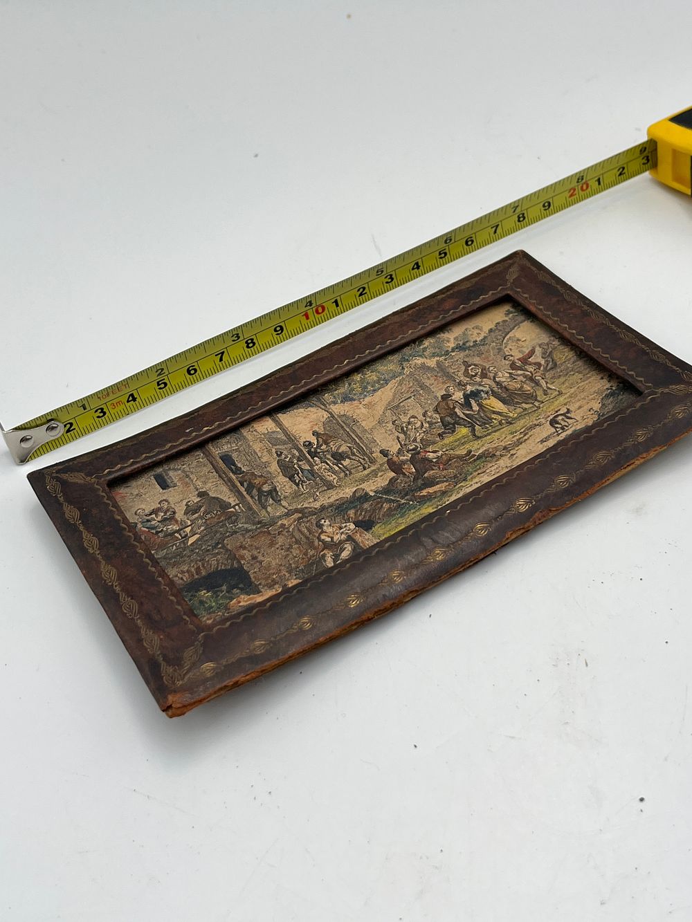 Lot 748: Antique Tooled Leather Desk Portfolio? With Inset Village Scene Print, 21.5cm