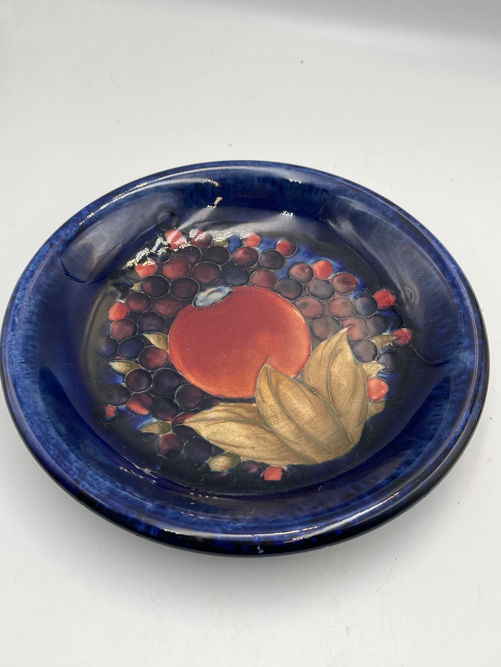 Lot 761: A Moorcroft Pomegranate Pattern Earthenware Shallow Bowl, 8"