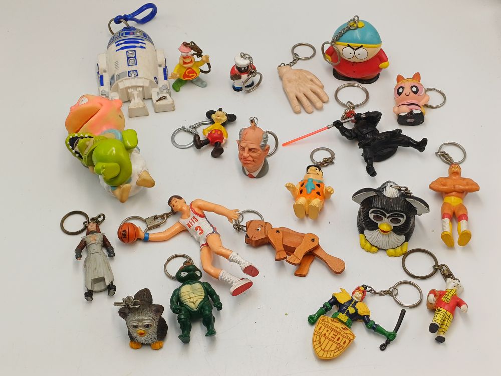 Lot 893: A Collection of Novelty PVC and Plastic Character Keyrings and Figures