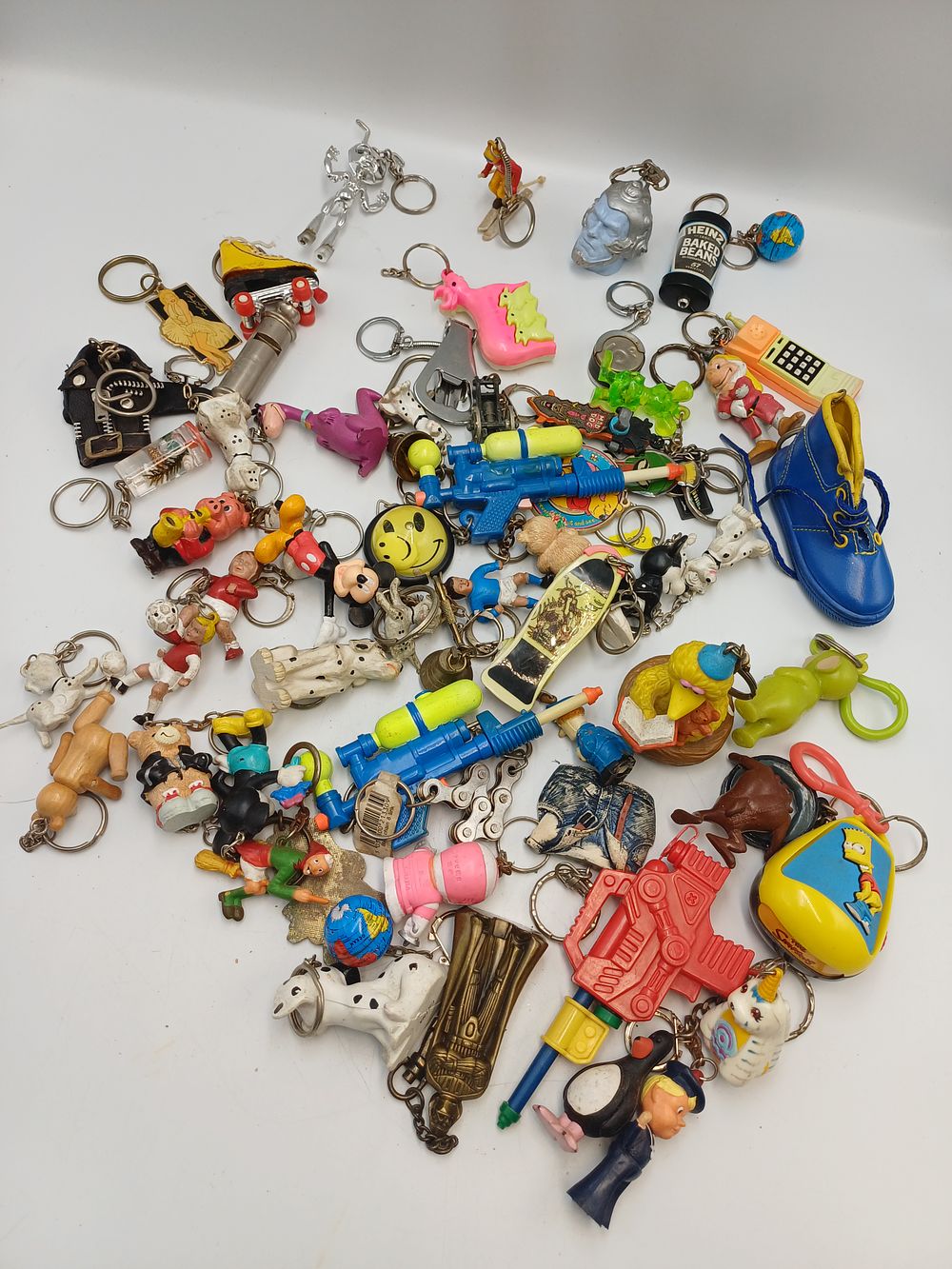 Lot 894: A Collection of Novelty Plastic and White Metal? Keyrings, Late 20th Century