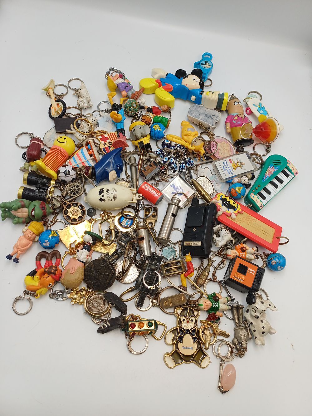 Lot 895: A Collection of Novelty PVC and Metal Keyrings and Figures, Late 20th Century