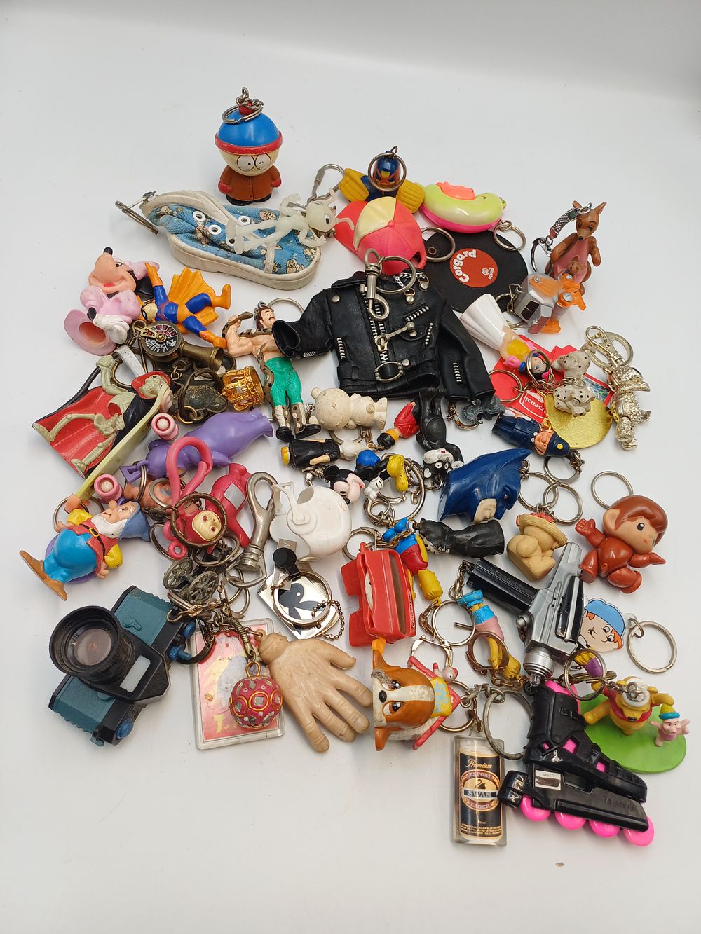 Lot 896: A Collection of Novelty and Pop Culture Keyrings and Figurines, Late 20th Century