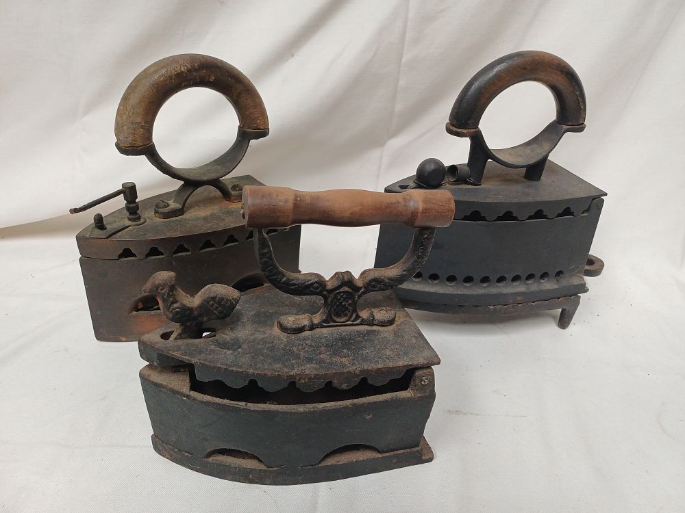 Lot 976: A Trio of Antique Cast Iron Coal Burning Irons