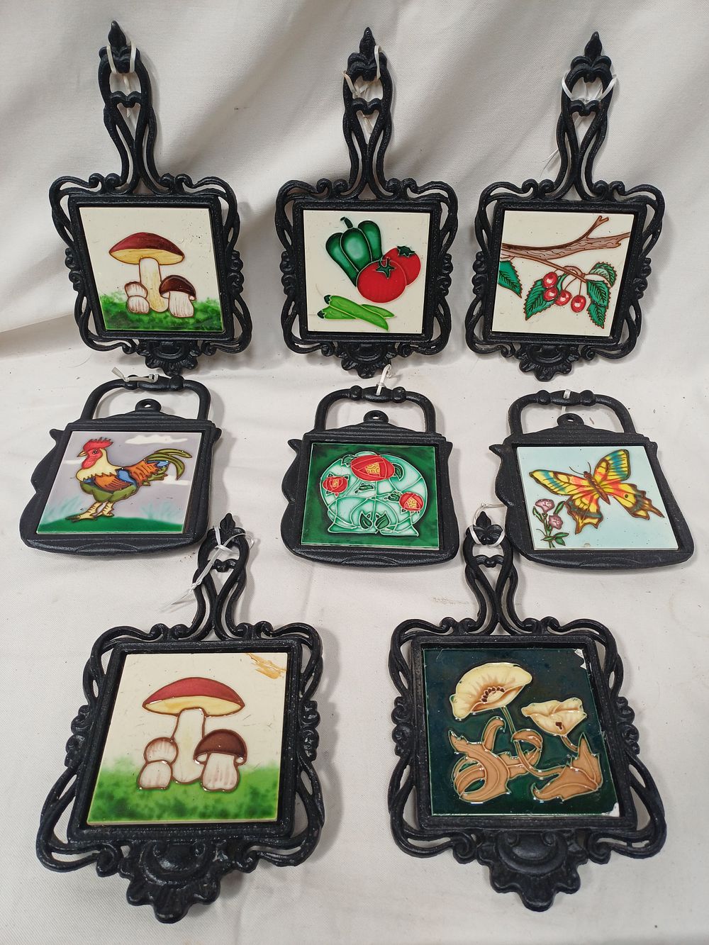 Lot 980: A Collection of Cast Iron and Ceramic Tile Kettle Trivets