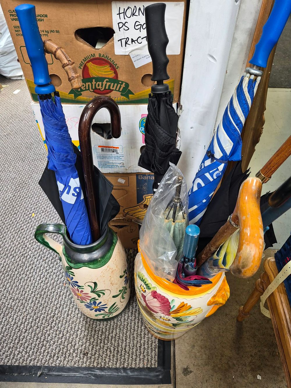 Lot 1023: Two Italian? Majolica Style Ceramic Umbrella Stands with Multiple Walking Sticks and Umbrellas