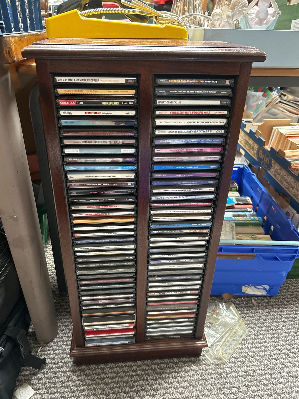 Lot 1059: A Collection of Country, Pop, and Easy Listening Compact Discs in Wooden Rack