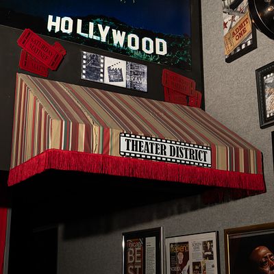 Theater District Awning. Cloth awning with fringe with attached sign for Theater District. 