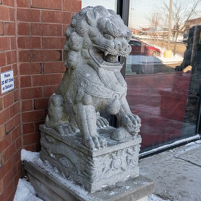 Large Stone Exterior Foo Dog. Large Chinese Foo Dog carved from stone located outside the 