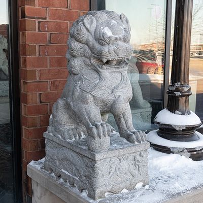 Large Stone Exterior Foo Dog. Large Chinese Foo Dog carved from stone located outside the 