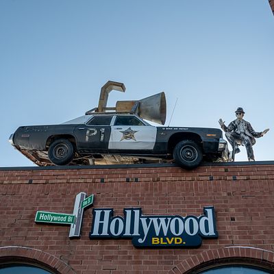 Blues Brothers Automobile & Statue. Sign mounted on top of the Hollywood Blvd. Cinemas theater 