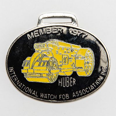 Vintage Watch FOB - IWFAI 1977 HUBER HEAVY EQUIP. Pre-owned. Dents, dings, scratches and other 