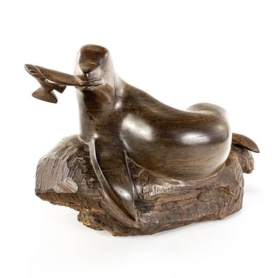 Hand-Carved Wood Seal W/Fish in Mouth. A mid-century modern style sculpture of a reclining seal 