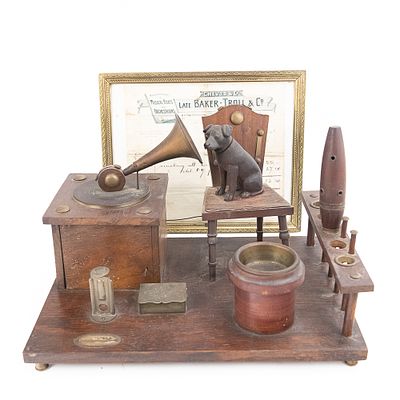 1907 His Master's Voice Smoking Set Music Box. A wood and metal smoking set depicting a stylized 