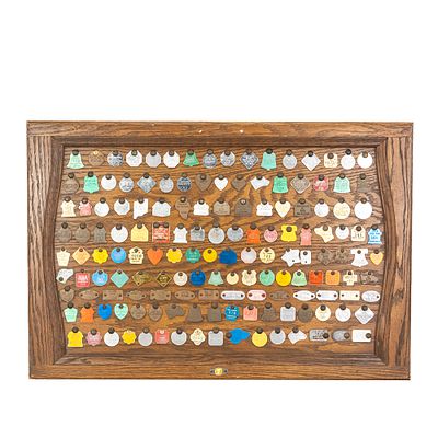 Vintage "Dog" Tag Display. Collection of over 140 assorted "Dog" animal tags; rabies, dog tax 