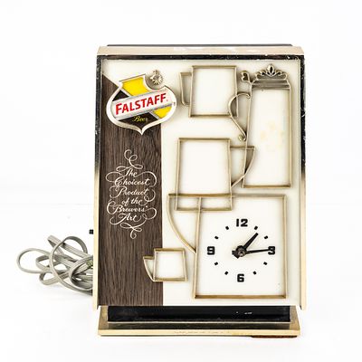 Vintage Falstaff Beer Lighted Motion Clock, features an integrated electric clock alongside a 