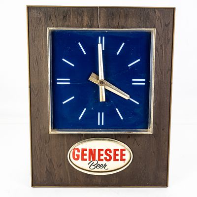 Vintage Genesee Beer Advertising Clock, featuring a blue face and faux-wood grain frame 