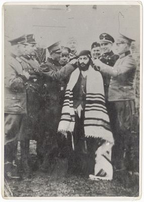 An Orthodox Jew being abused by Nazis in Koźnica, Poland. September, 1939. Policemen and an SS 