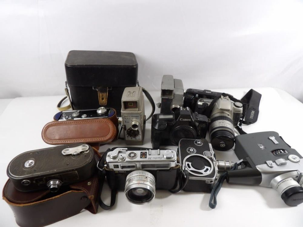 Lot 386: Large Lot of Vintage Cameras and 8mm Cameras.