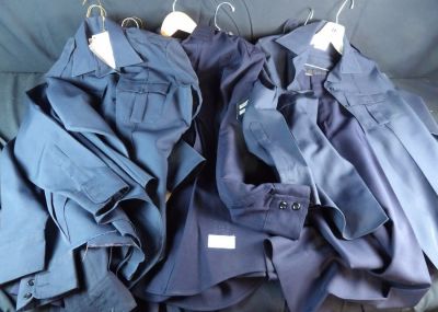 Large lot of Movie Costume Police uniforms and pants. Most Marked with Names and some have 