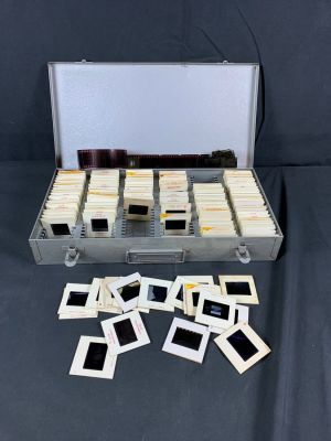 Large lot of Vietnam War Era Navy Slides and Case. Some slides are loose and may show signs of 