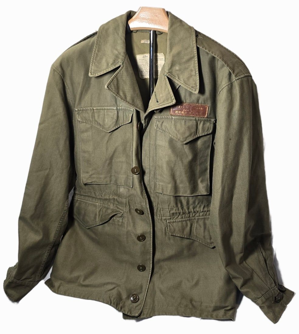 Lot 16: WWII RARE M43 with Chinese leather name tag.Named.