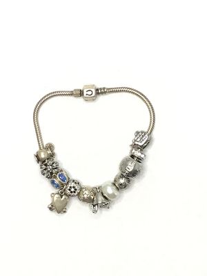 Sterling silver bracelet. Sterling bracelet with numerous dangles. 47.76 grams total weight. 8 