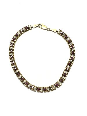 10k gold bracelet. 10K yellow gold bracelet featuring spinel gemstones. Missing stone. 7.22 
