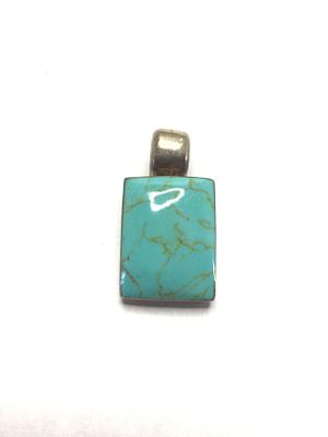 Artisan made pendant. Sterling pendant with turquoise colored stone. 12.48 grams total weight. 