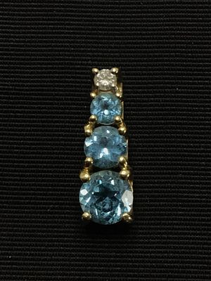 14k gold pendant. 14K yellow gold pendant featuring diamond and blue topaz gemstones. 1.15 grams 
