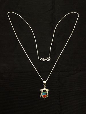 Artisan made pendant with chain. Sterling silver pendant and chain with multiple stone inlay. 