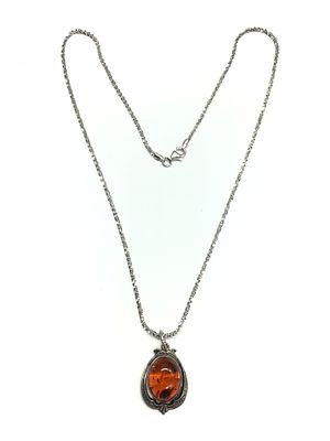 Sterling silver necklace with pendant featuring possible Amber stone. 6.30 grams total weight. 