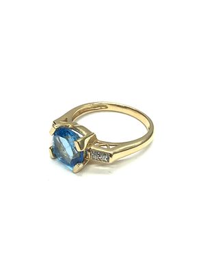 14k gold ring. 14K yellow gold ring featuring blue topaz and small diamond gemstones. 4.50 grams 