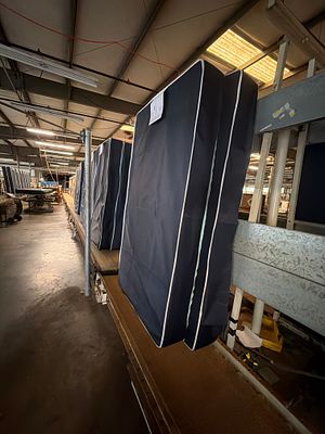 Vertical mattress conveyer. Does have carousel the bring them down from the build side to the 