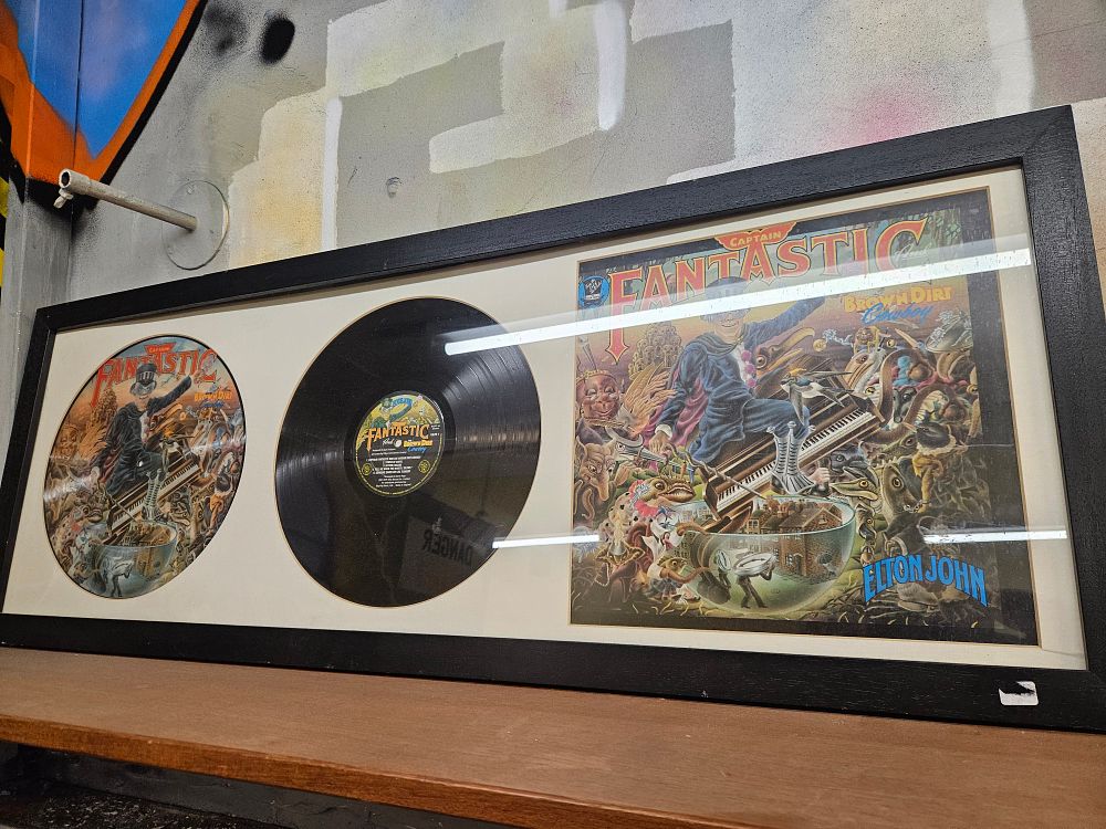 Lot 175 – Elton John Captain Fantastic and the Brown Dirt Cowboy Framed Vinyl Record and Artwork Display