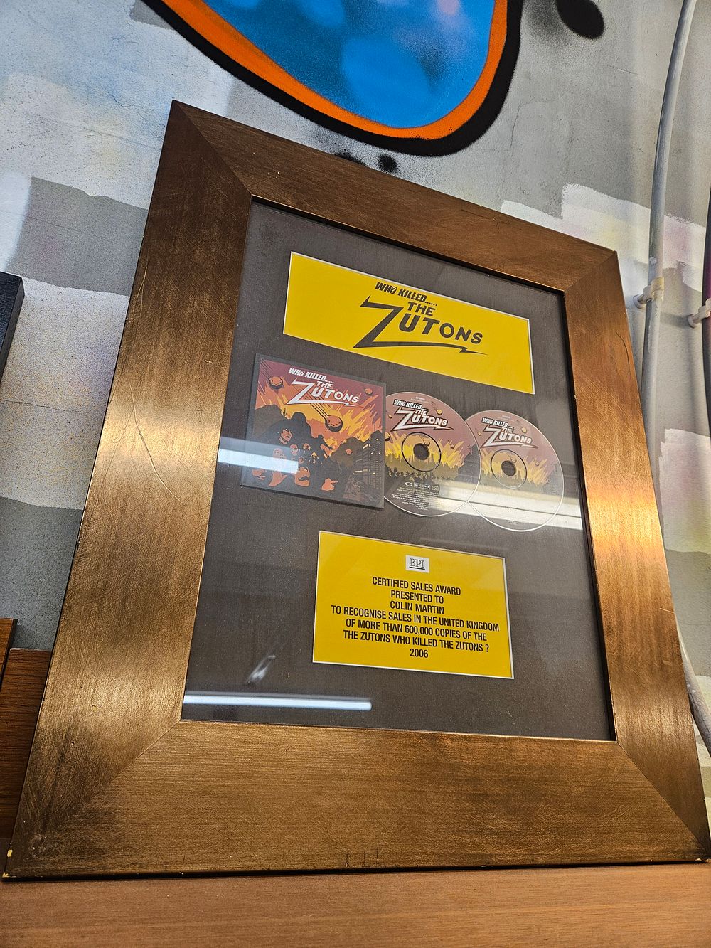 Lot 176 – BPI Platinum Sales Award Presented to Colin Martin for The Zutons Album Who Killed…… The Zutons