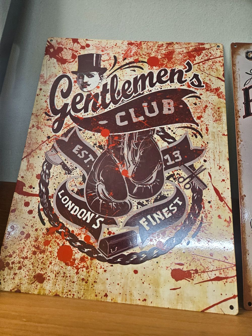 Lot 182 – A Modern Printed Metal Wall Sign with Boxing and Barbering Graphics