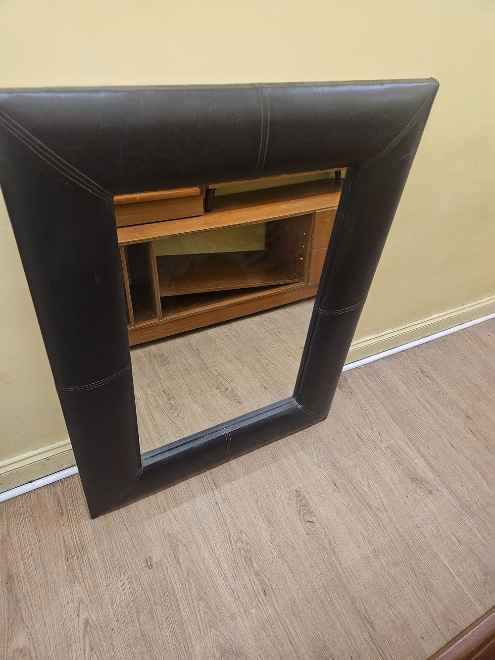 Lot 203 – A large contemporary wall mirror with a dark brown leather-effect upholstered frame