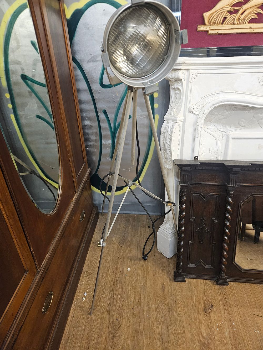 Lot 214 – An Industrial Metal Tripod Floor Lamp with General Electric Spotlight Head