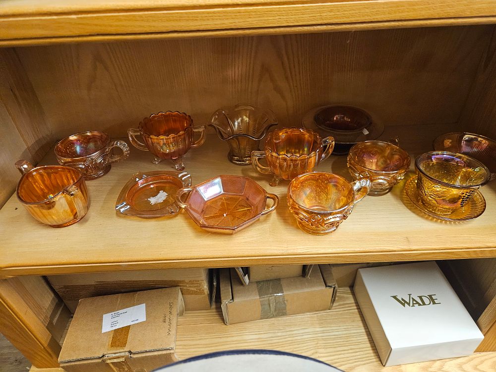 Lot 327 – A collection of approximately ten pieces of marigold iridescent carnival glass including Iris and Herringbone and Hobstar patterns