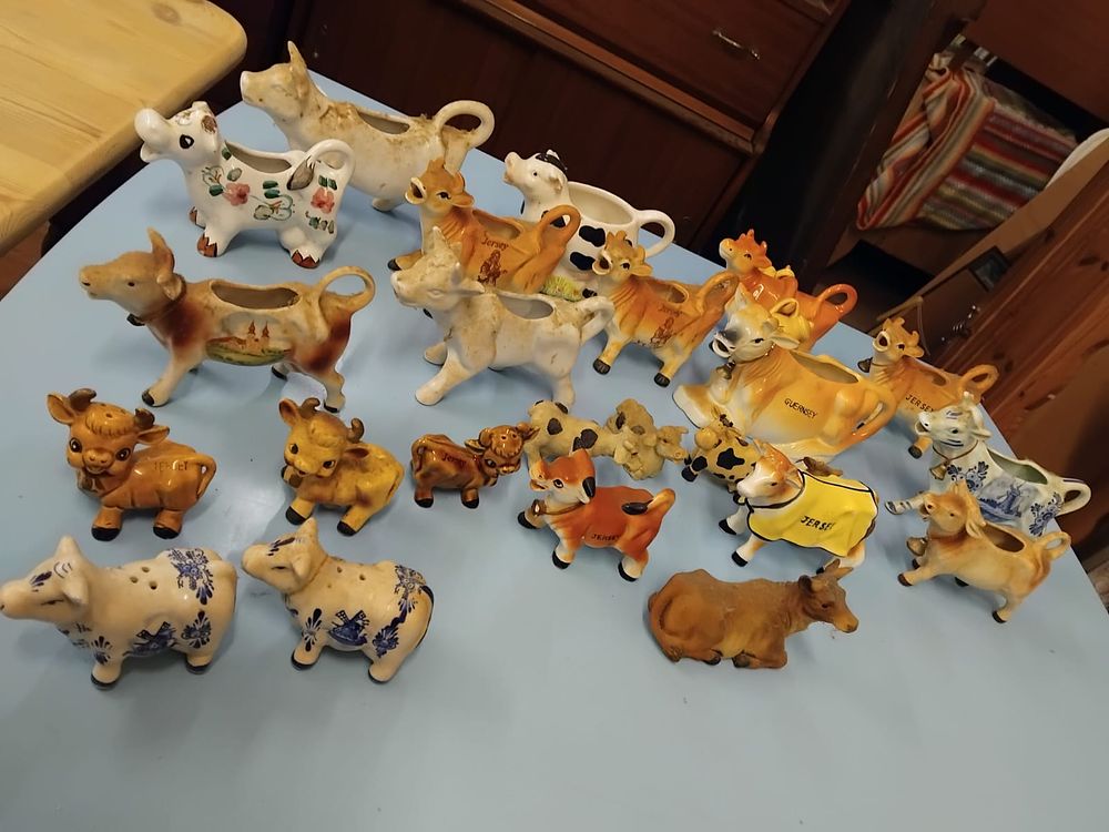 Lot 333 – A Collection of Ceramic Cow-Themed Creamers, Figurines, and Tableware some delft