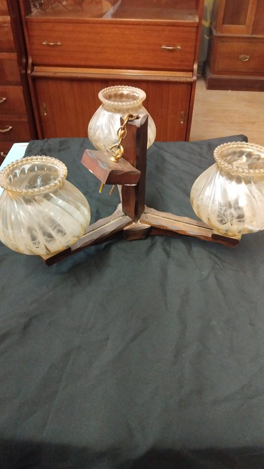Lot 337 – A Mid-Century Modern style three-branch dark wood ceiling light fixture with iridescent glass shades