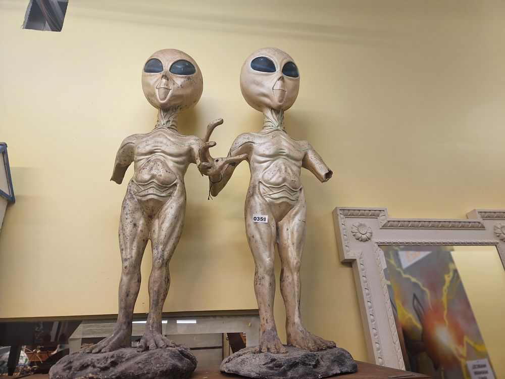 Lot 359 – A pair of cast resin sculpture of a Grey alien